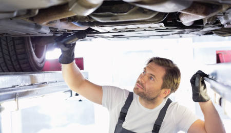 Man instpecting underneath a car